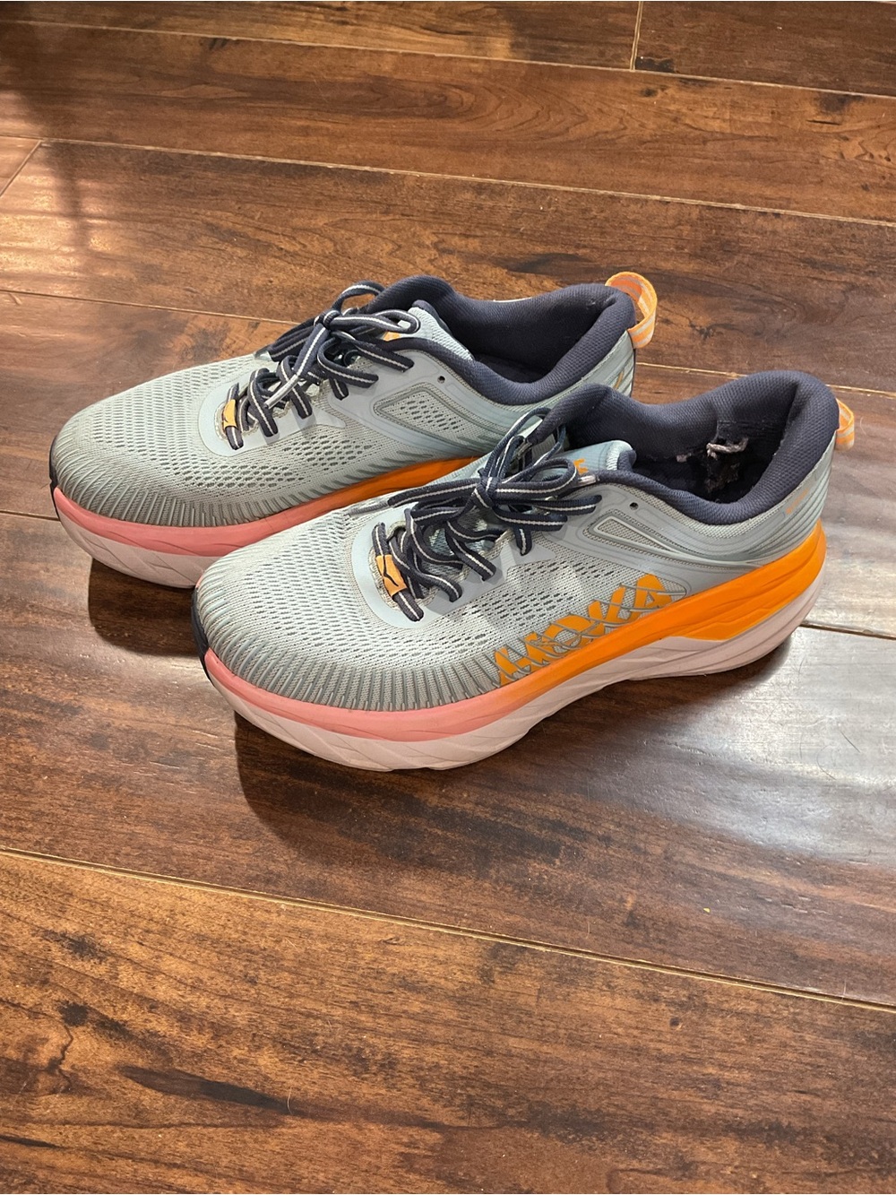 Hoka Blue Athletic Shoes with Orange and Pink Accents